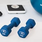 Two 2 Kg. Blue Hex Dumbbells on White Surface